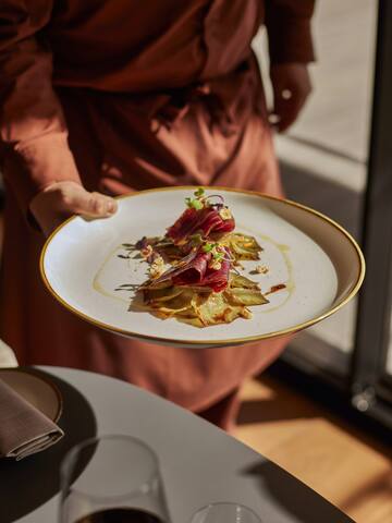 a person holding a plate of food