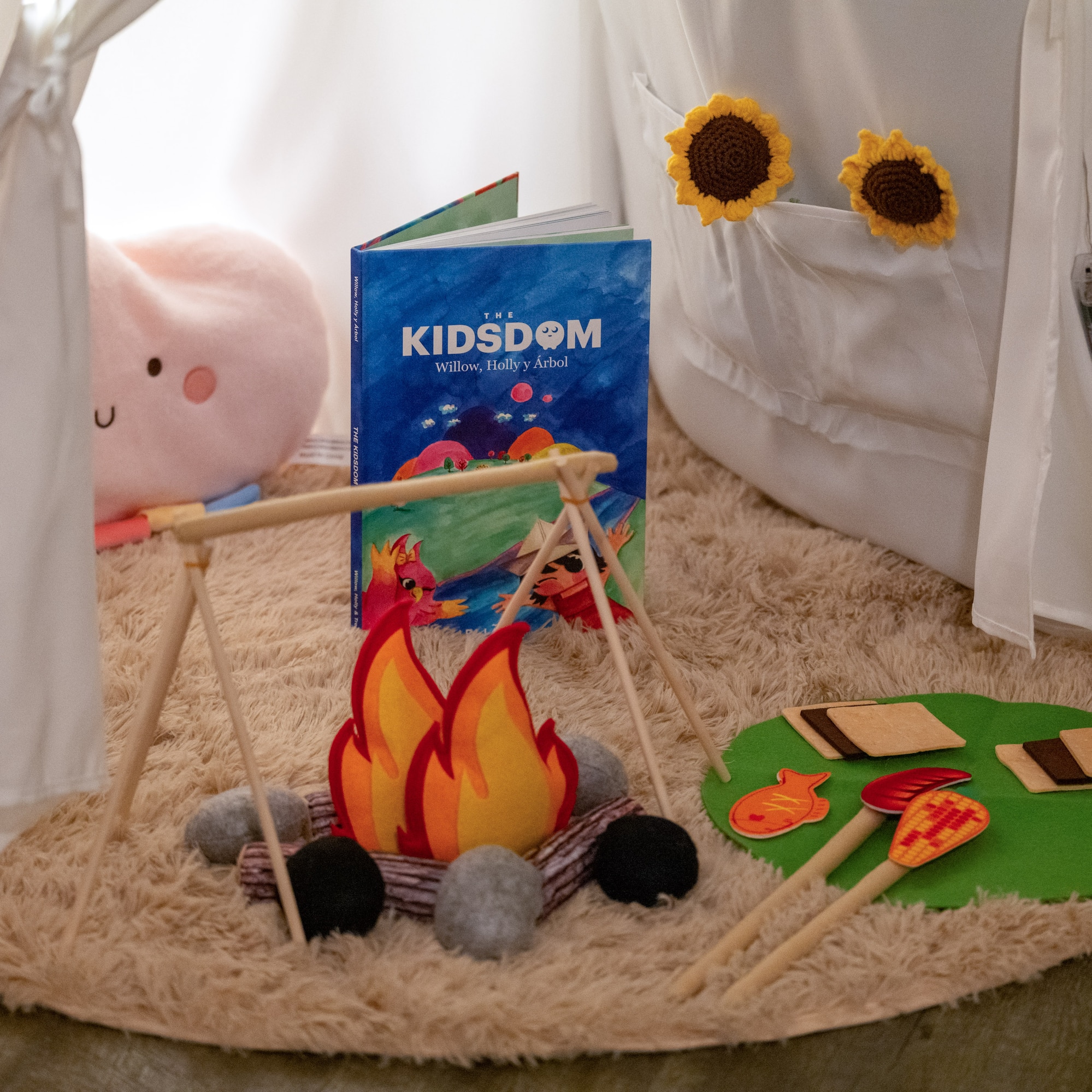 a toy campfire and a book on a rug