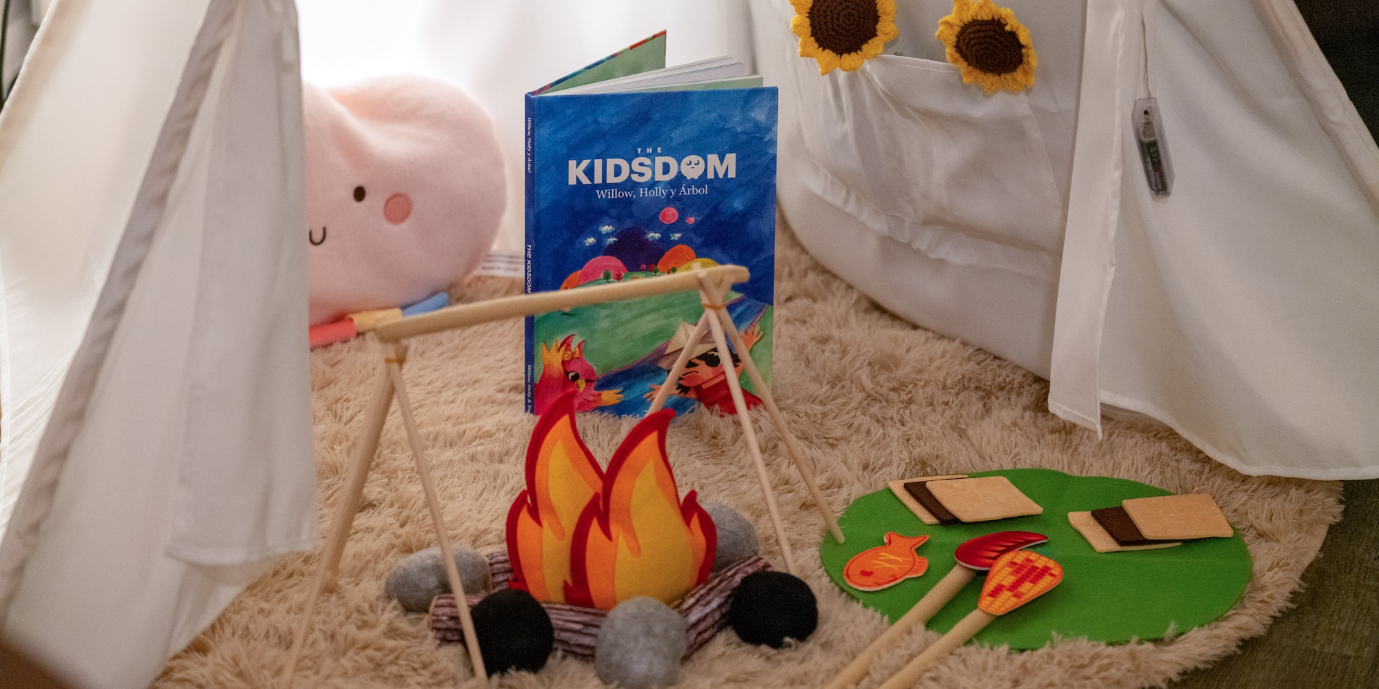 a toy campfire and a book on a rug