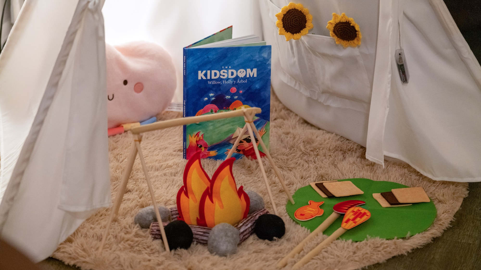 a toy campfire and a book on a rug