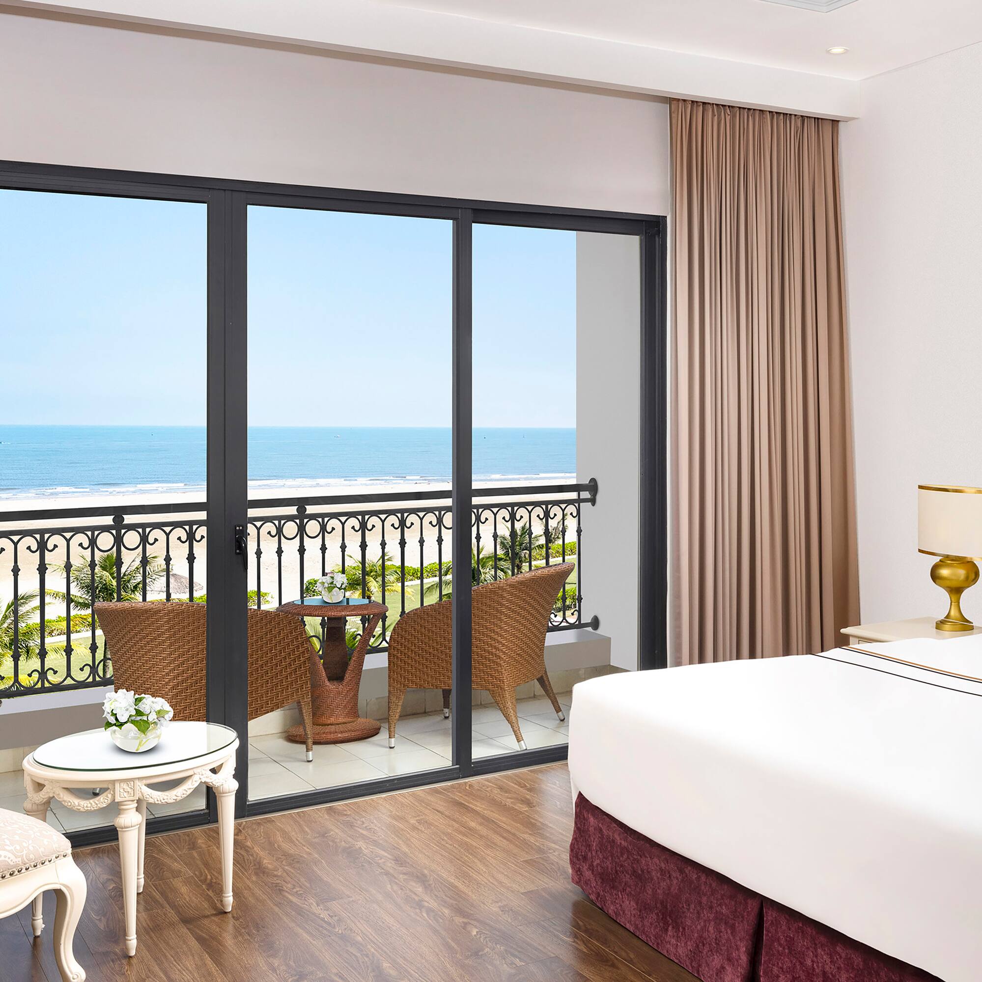 a room with a balcony overlooking the ocean