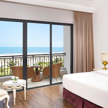 a room with a balcony overlooking the ocean