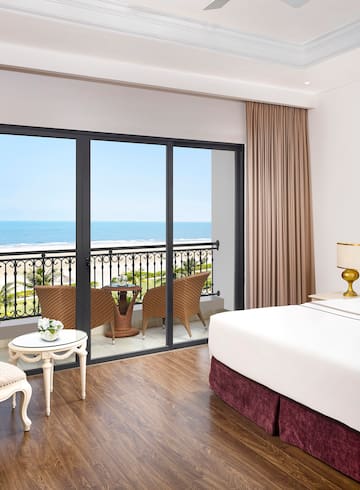 a room with a balcony overlooking the ocean