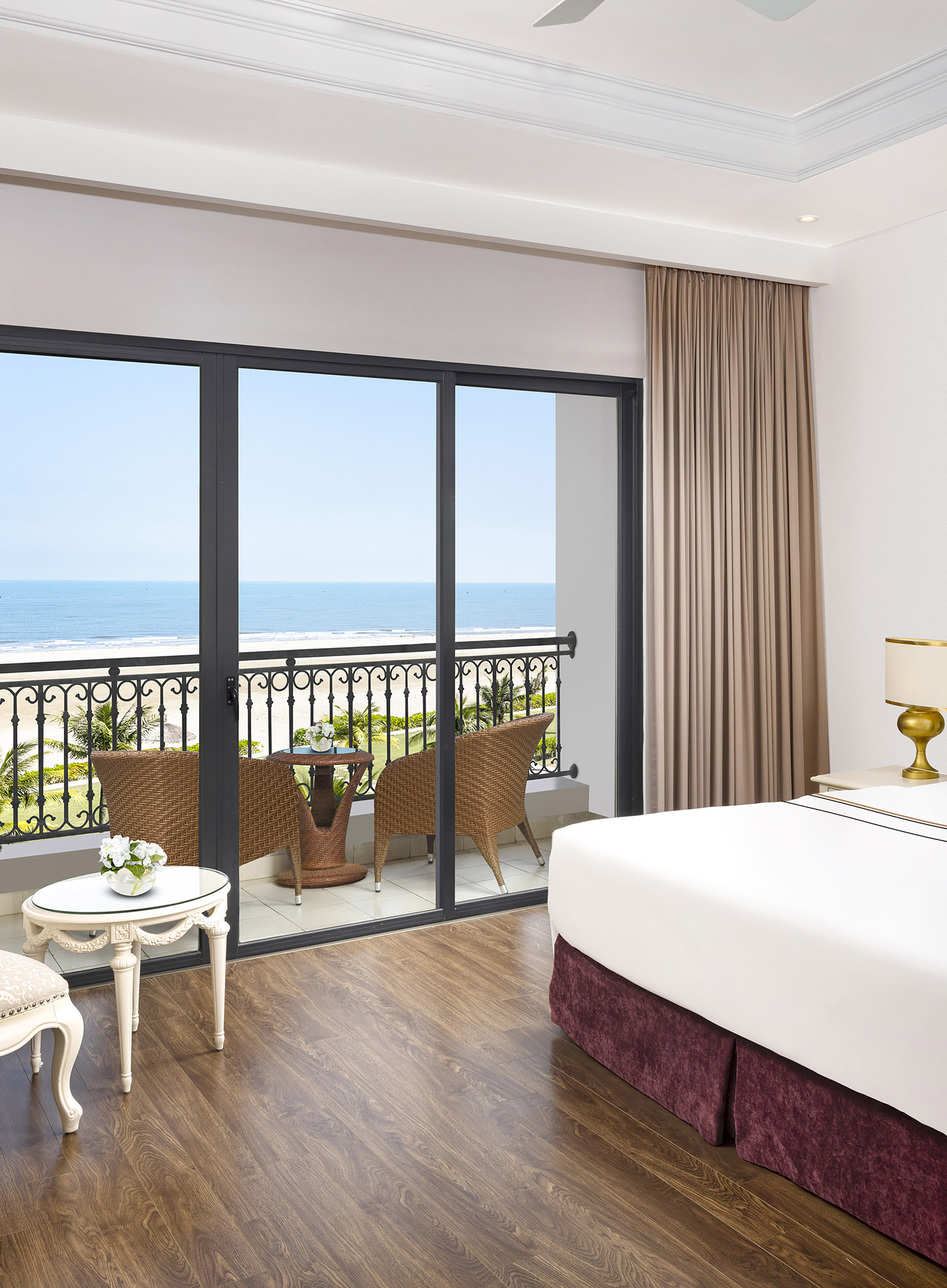 a room with a balcony overlooking the ocean