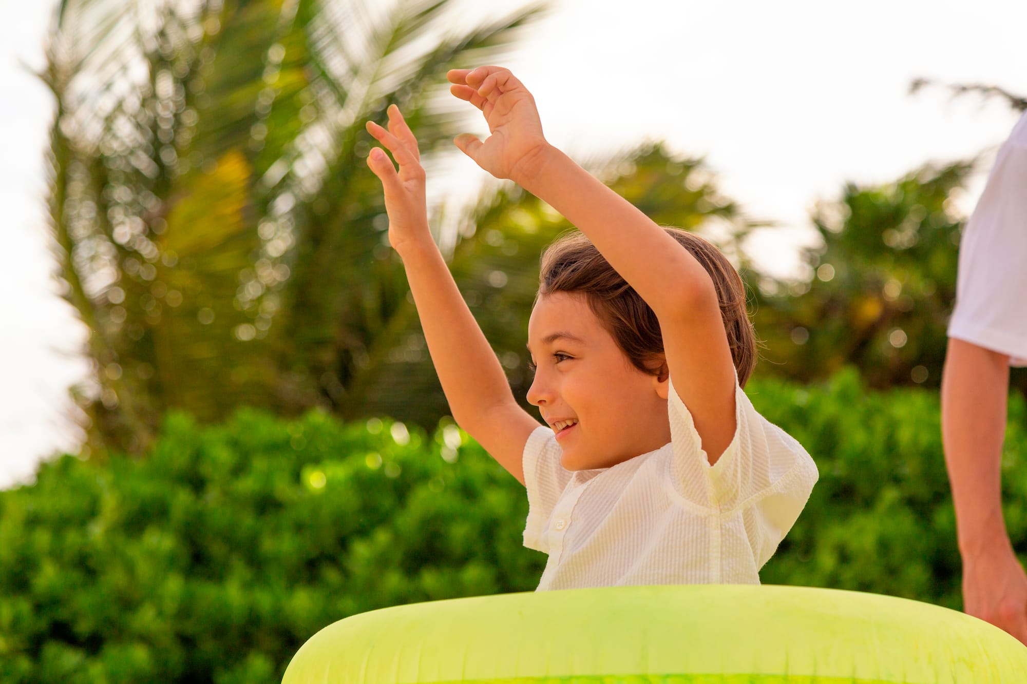 a boy with his hands up in the air