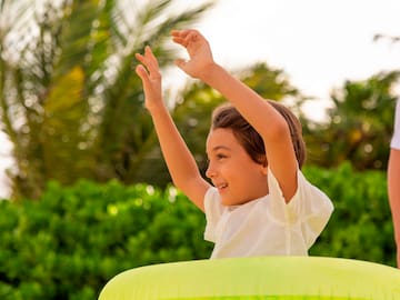 a boy with his hands up in the air