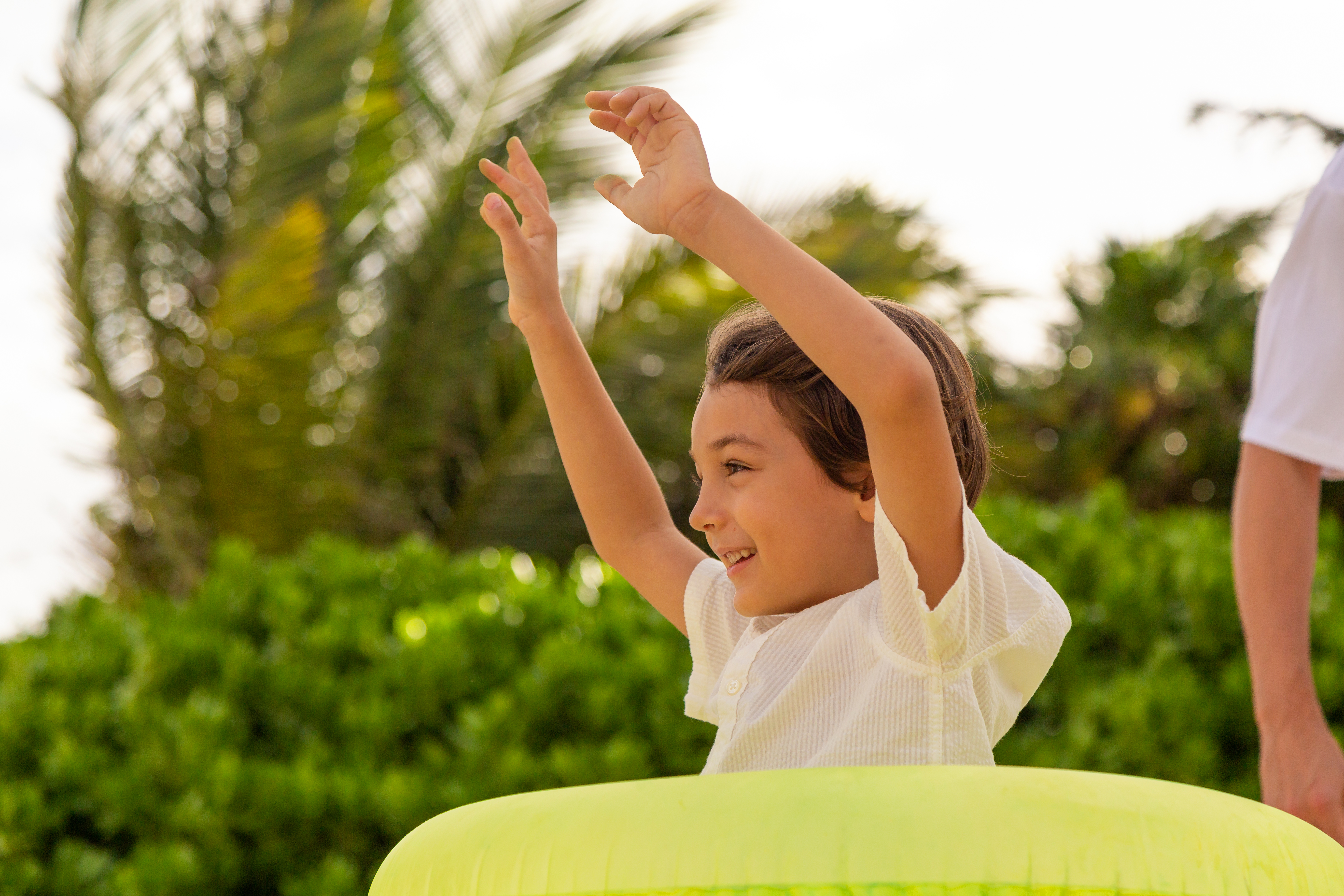a boy with his hands up in the air