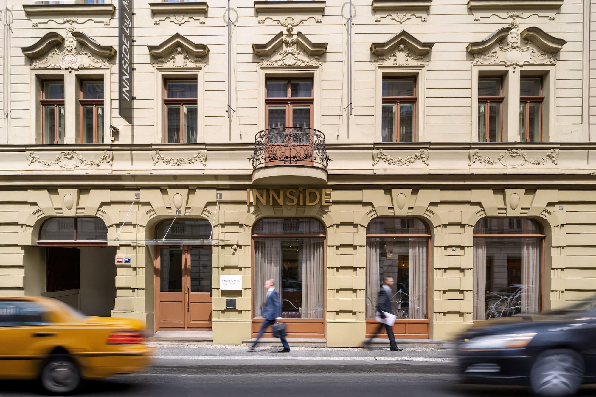 Ornate cream Innside by Meliá Prague Old Town hotel facade, street level.