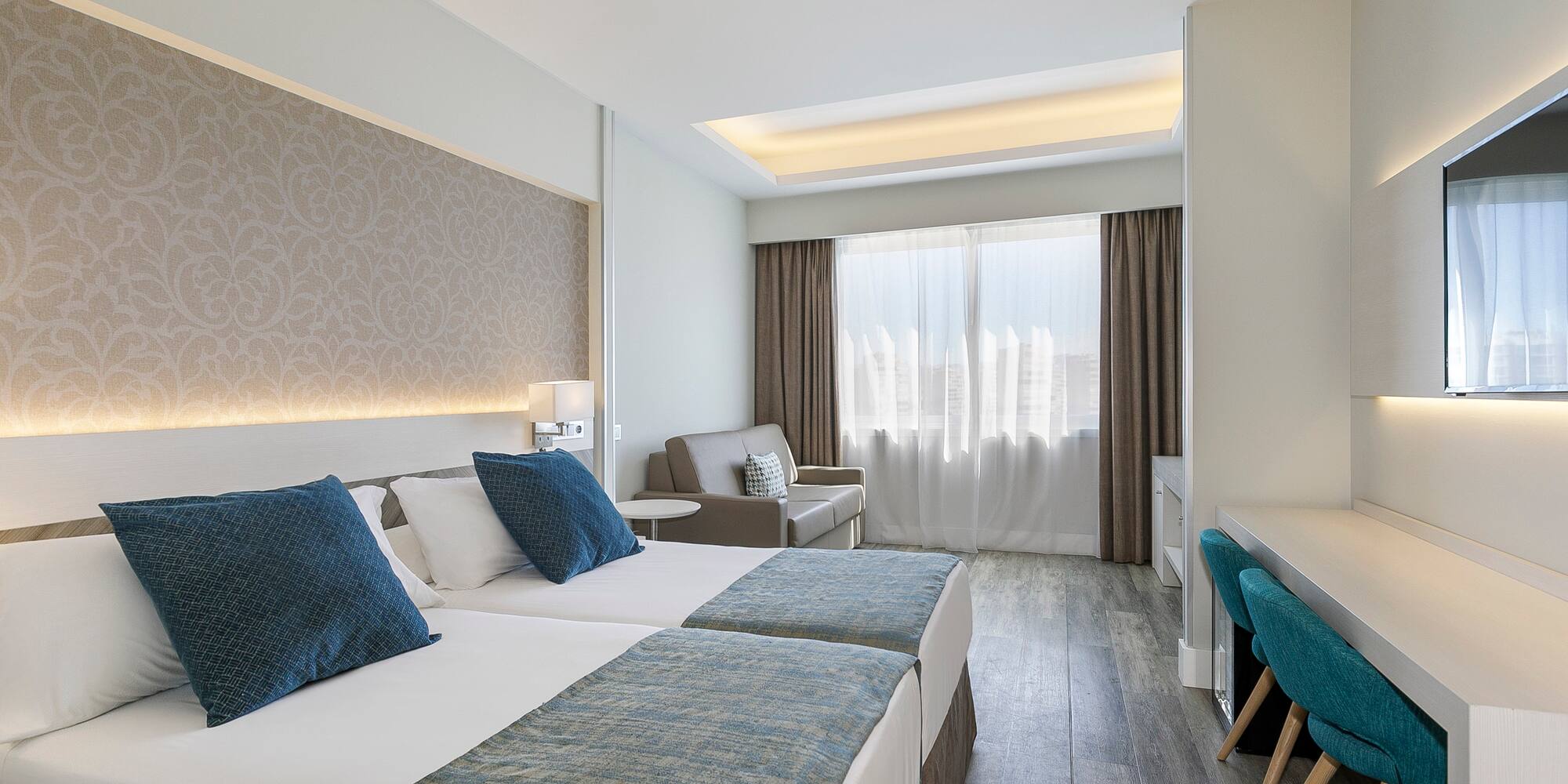 a room with two beds and a desk