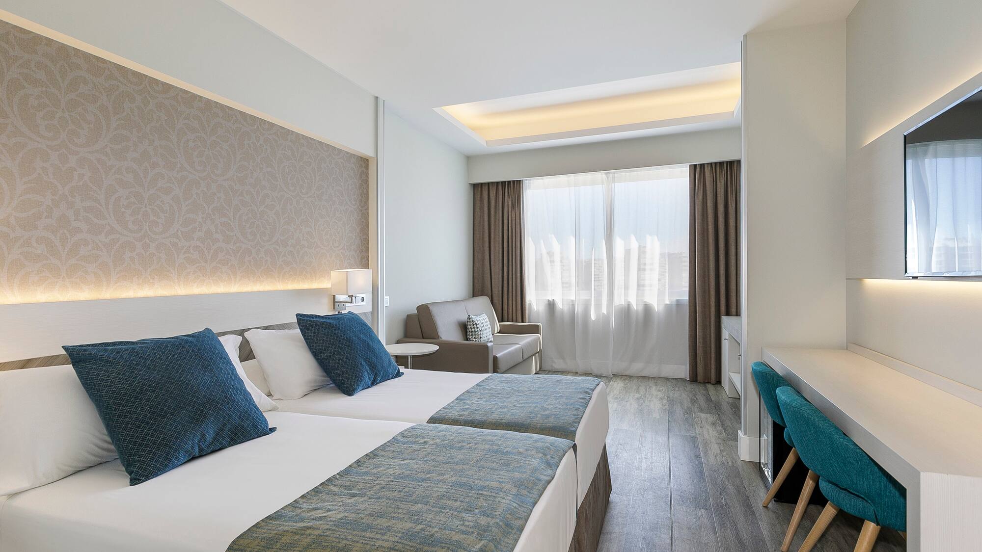 a room with two beds and a desk