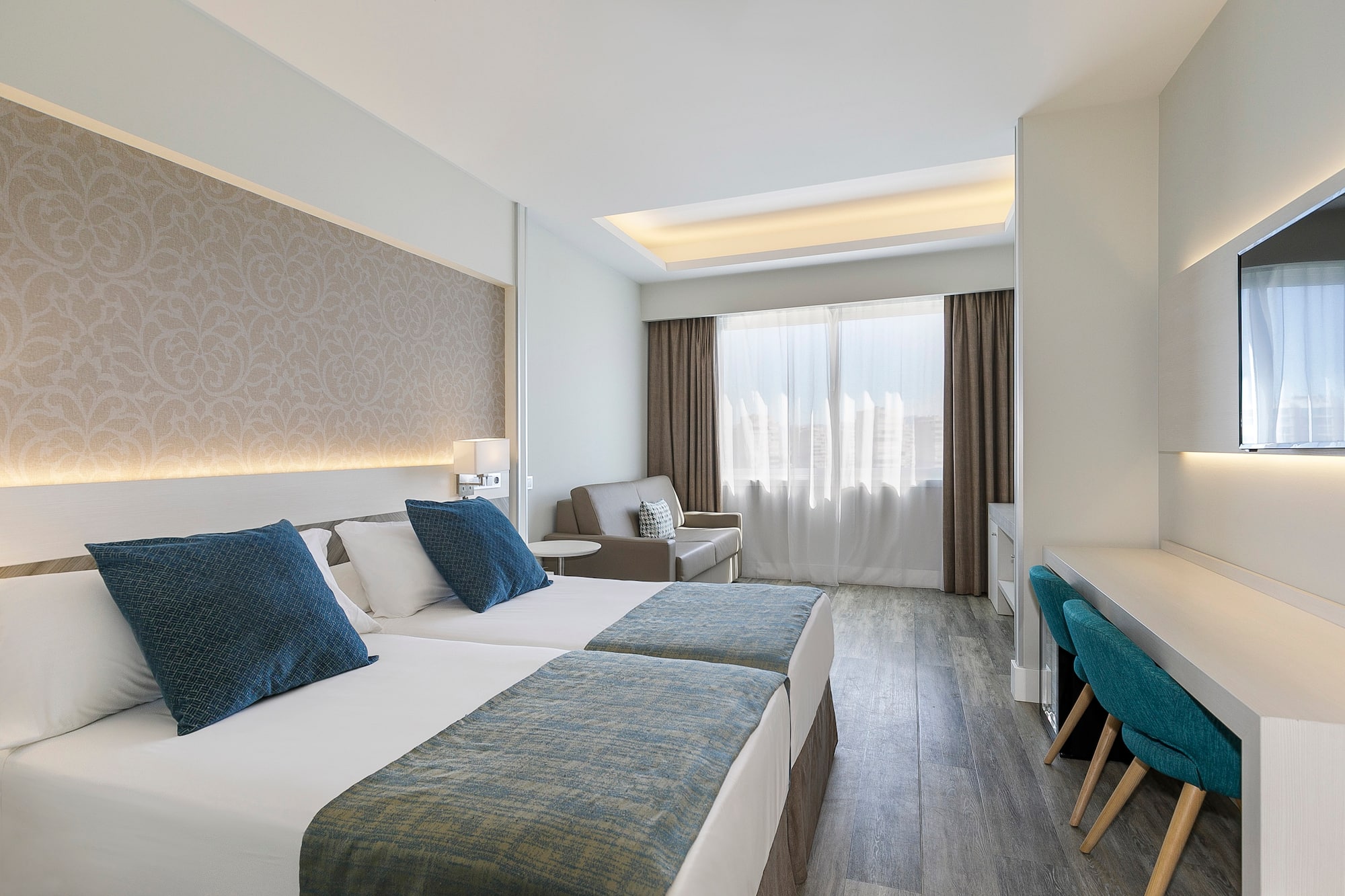 a room with two beds and a desk