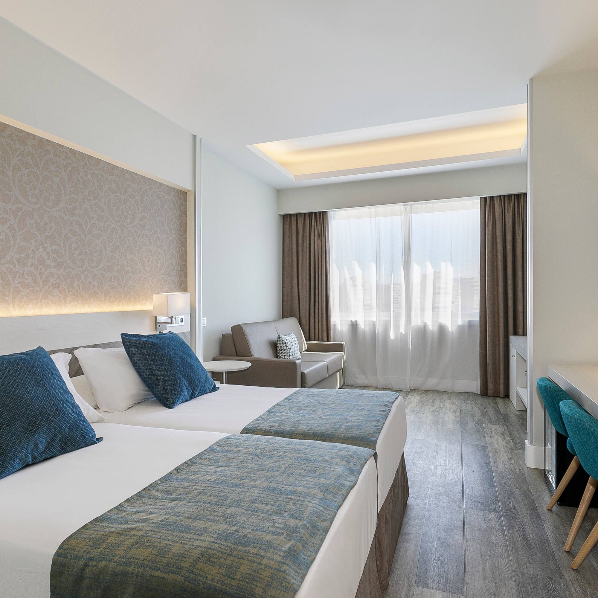 a room with two beds and a desk