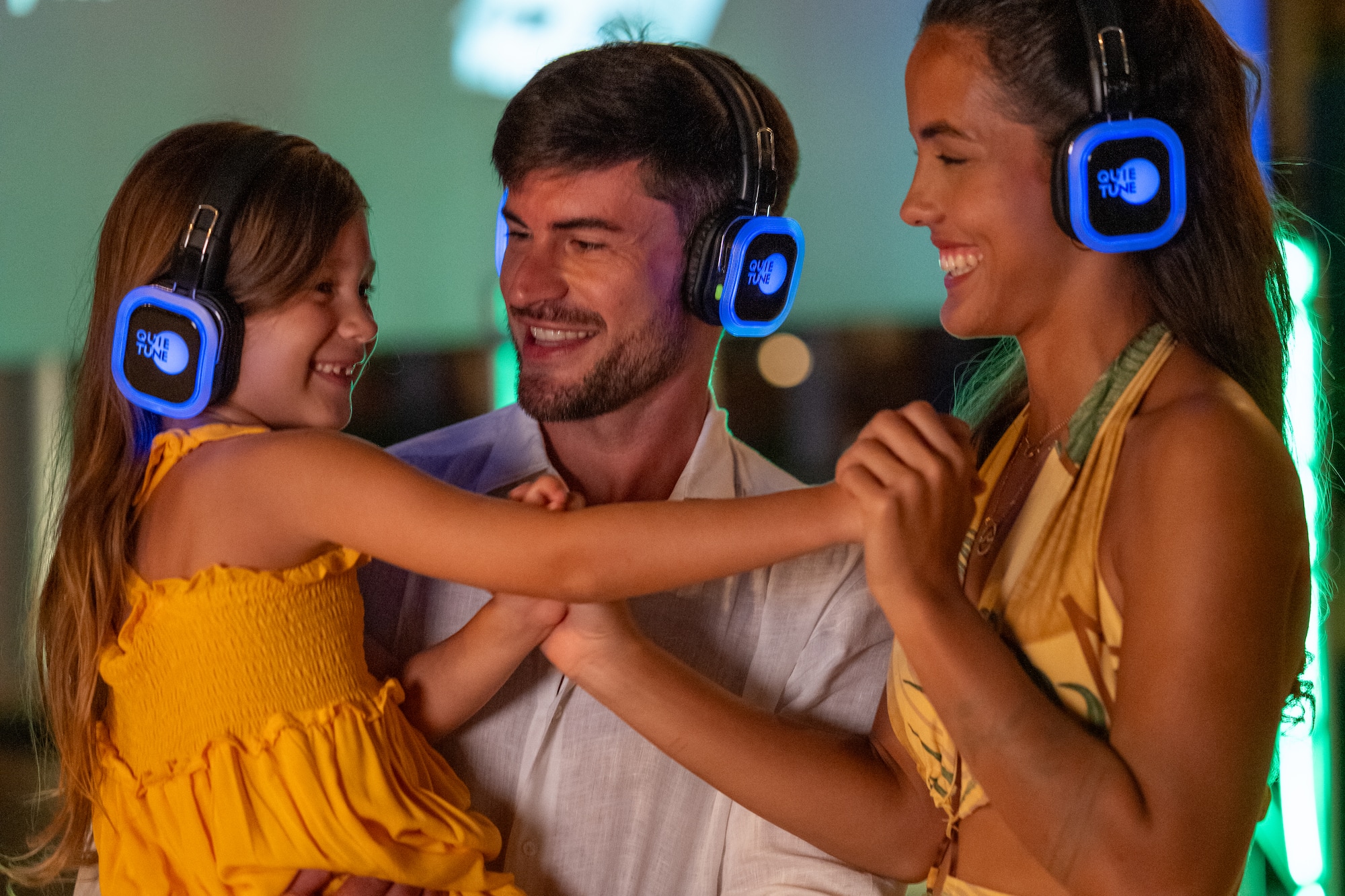 a man and woman with a child wearing headphones