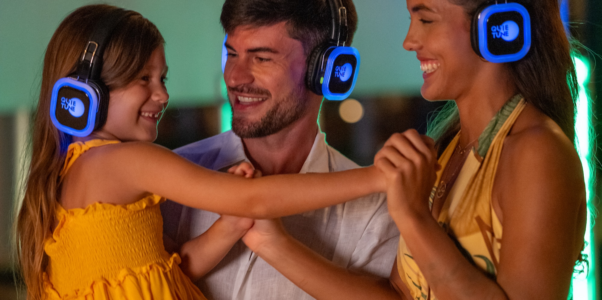 a man and woman with a child wearing headphones