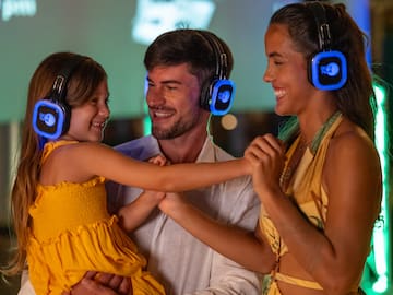 a man and woman with a child wearing headphones