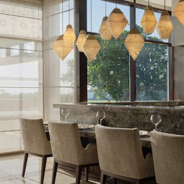 a dining room with a table and chairs