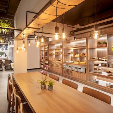 a room with a table and chairs and a shelf with food