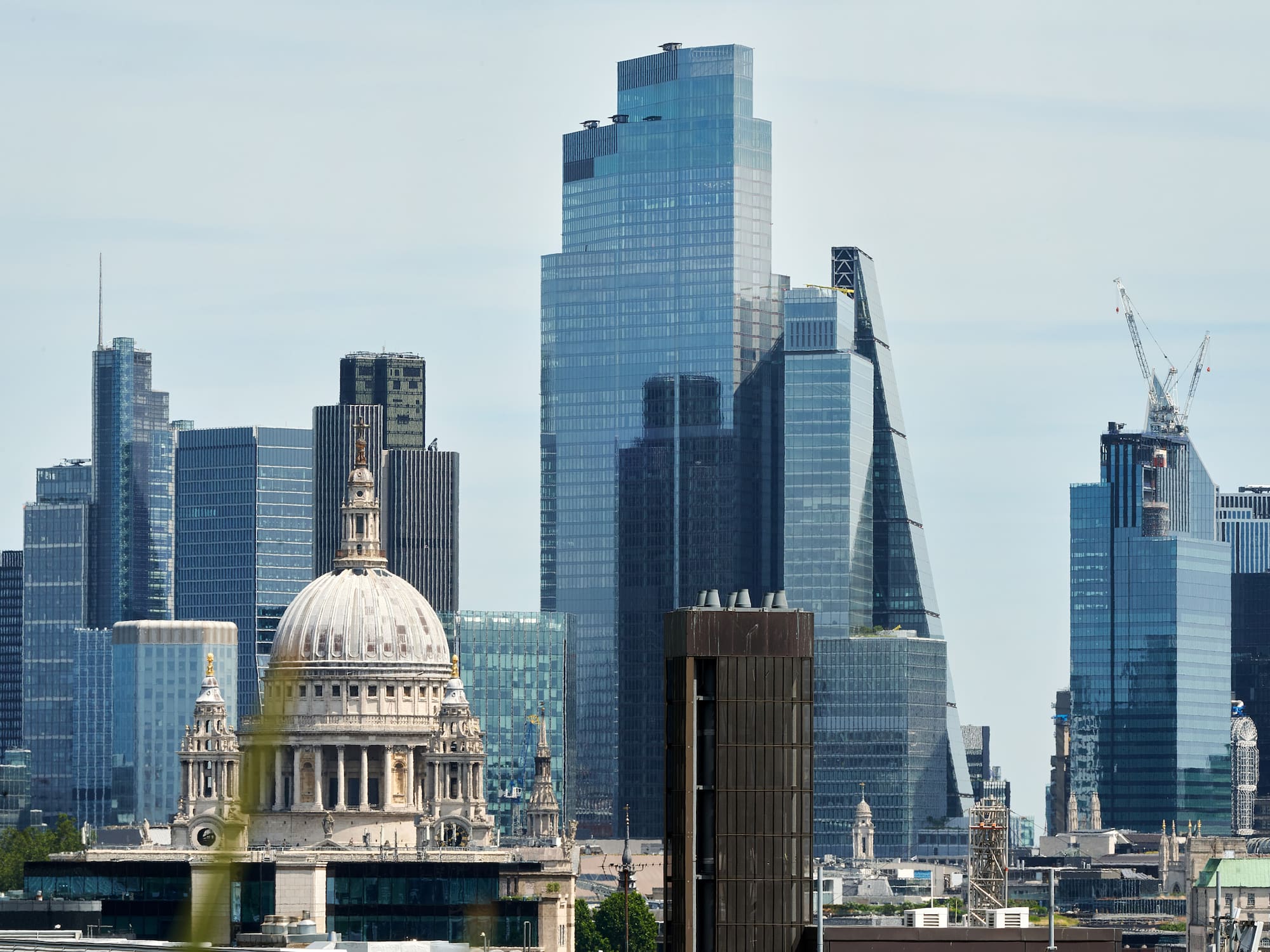A city skyline featuring a prominent building among several tall structures.