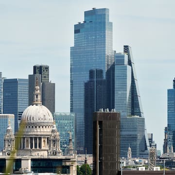 a city skyline with a large building and tall buildings