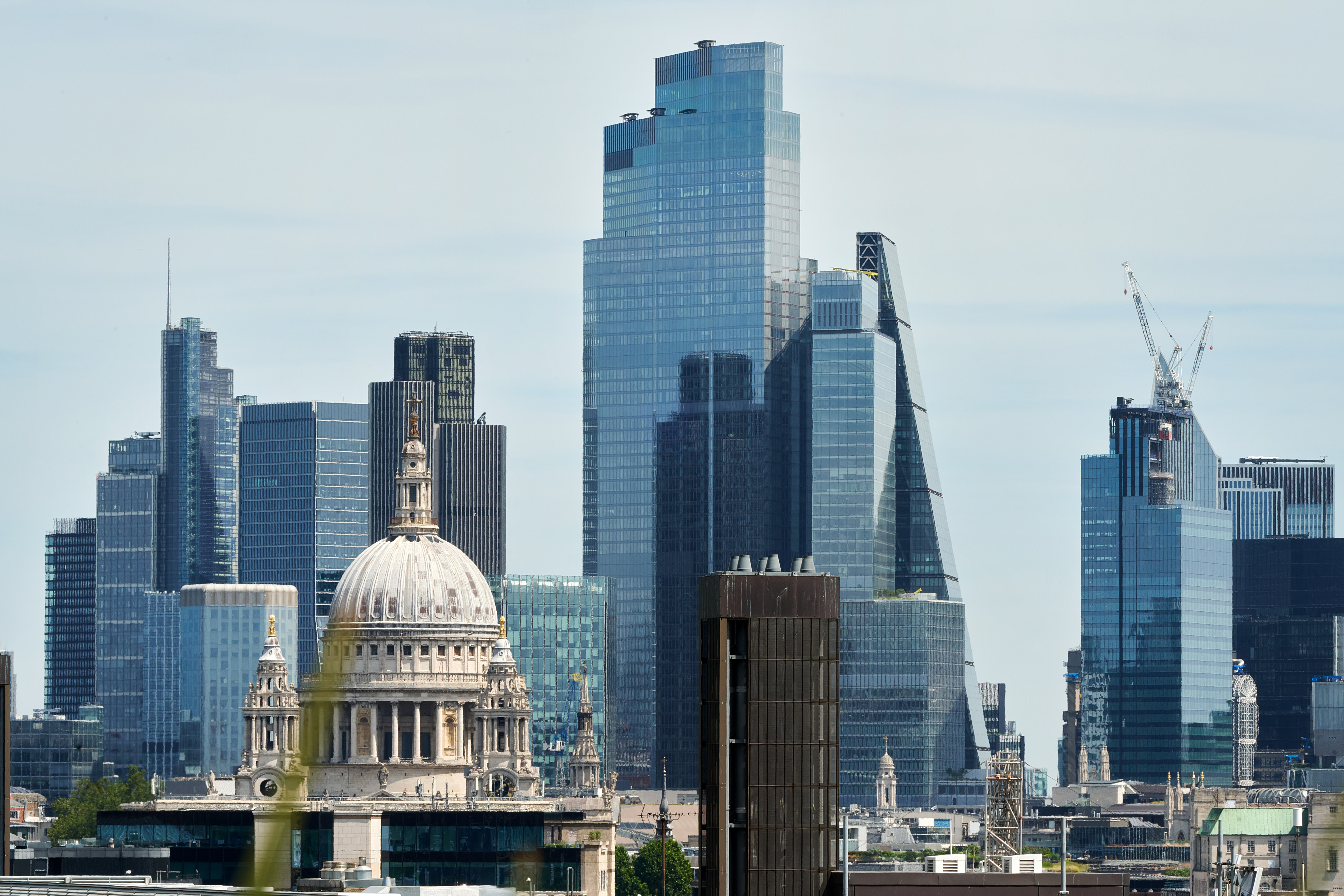 A city skyline featuring a prominent building among several tall structures.