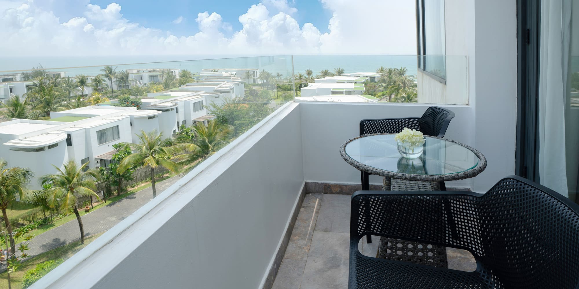 a balcony with chairs and table