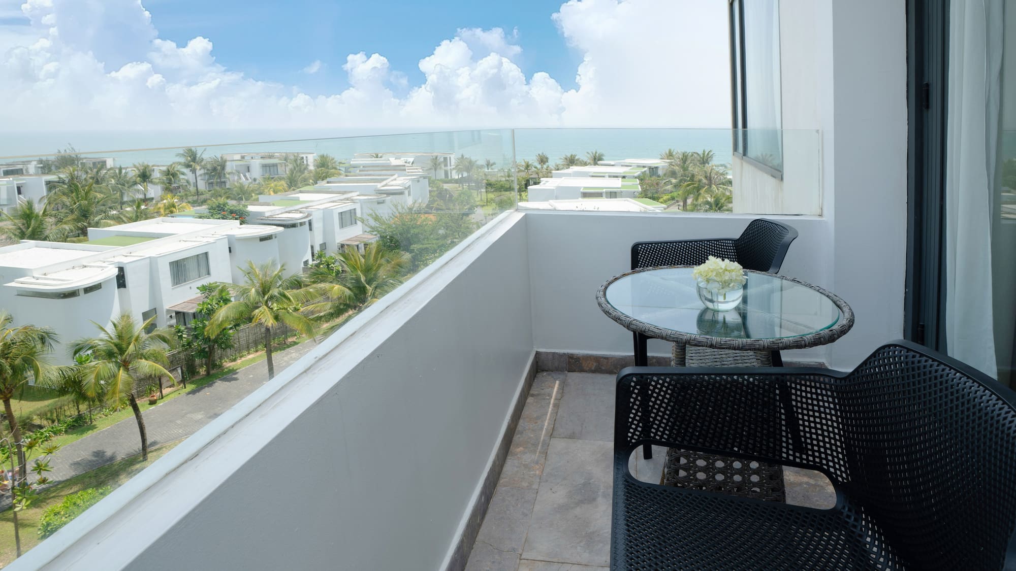 a balcony with chairs and table