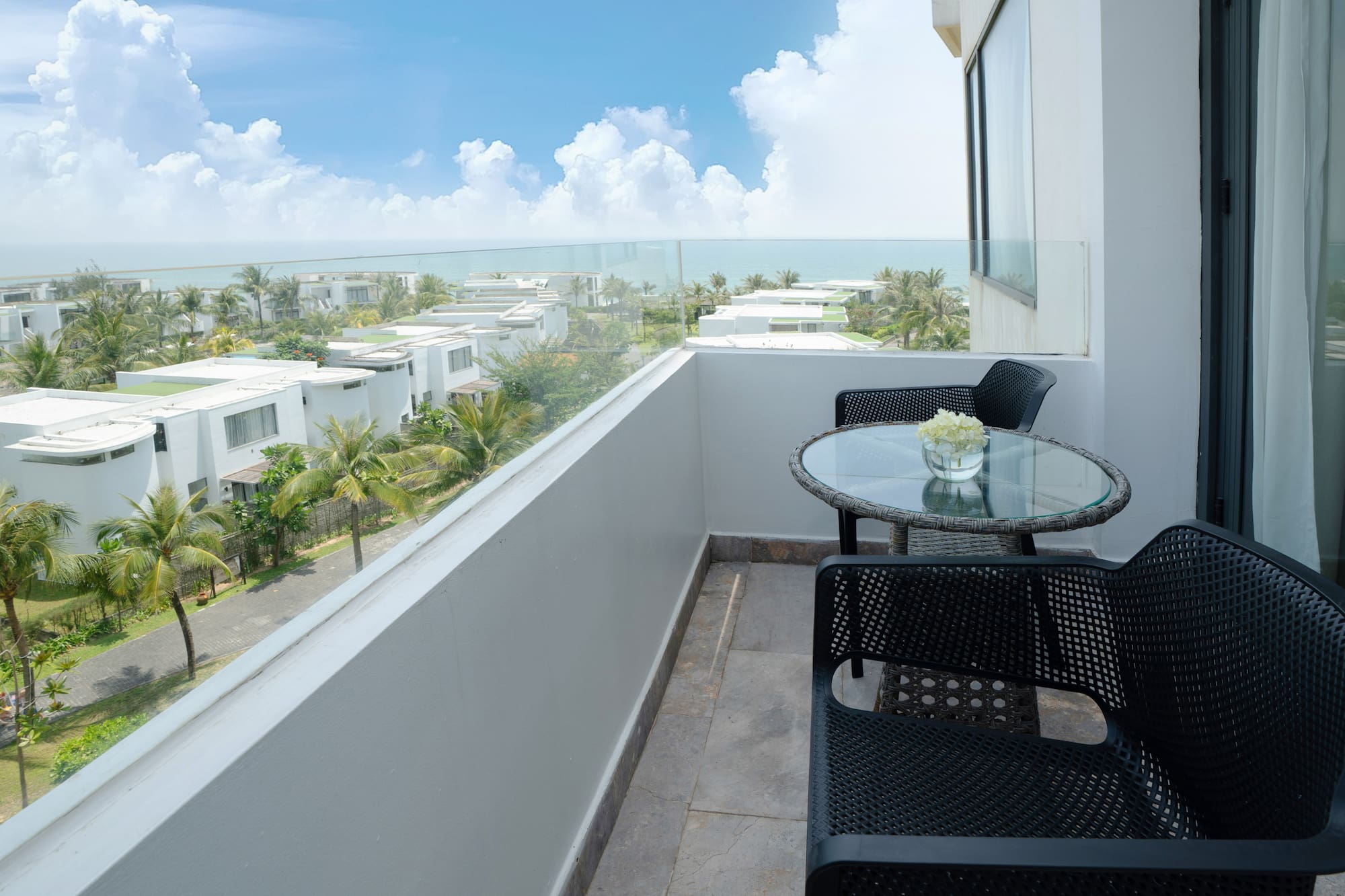 a balcony with chairs and table