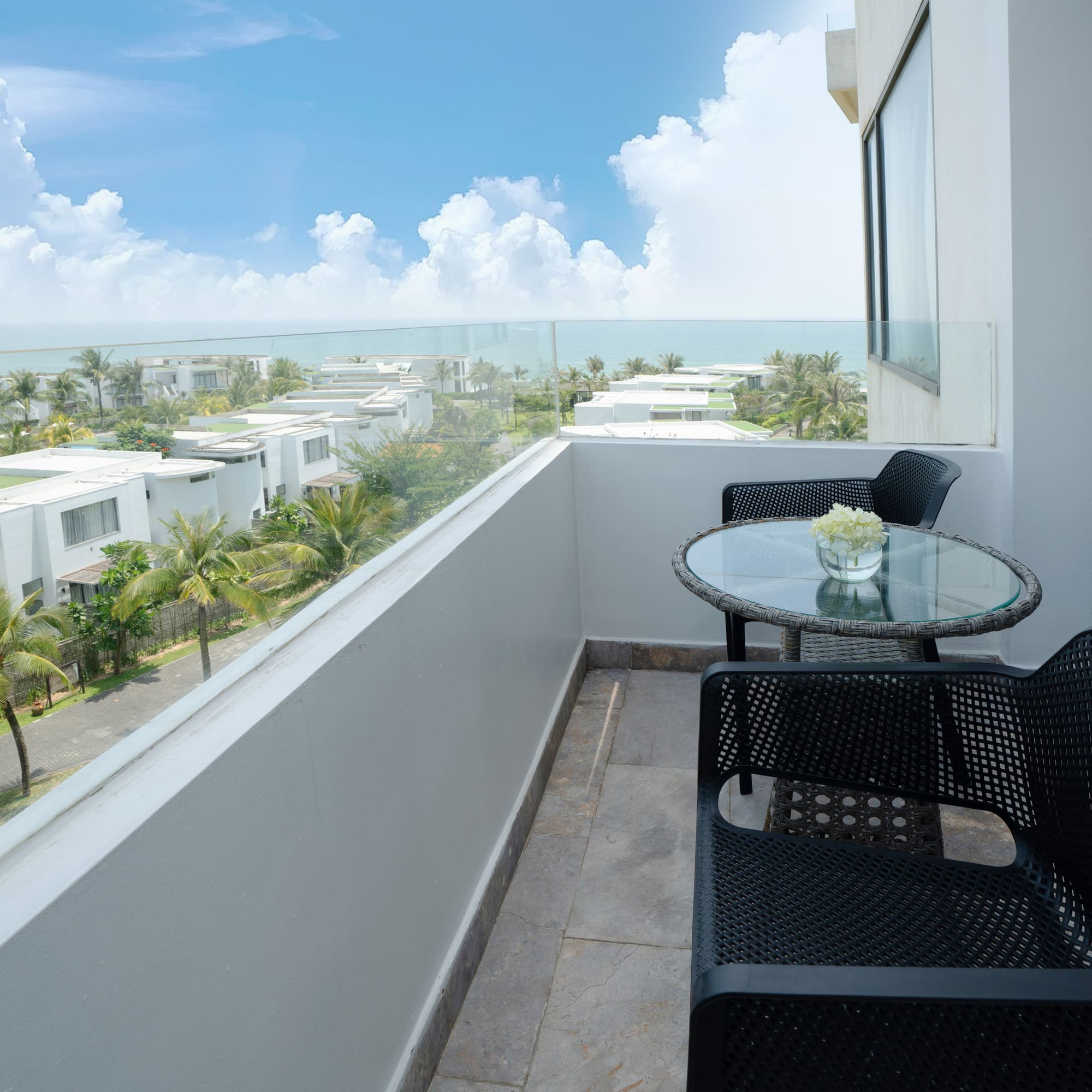 a balcony with chairs and table