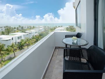 a balcony with chairs and table