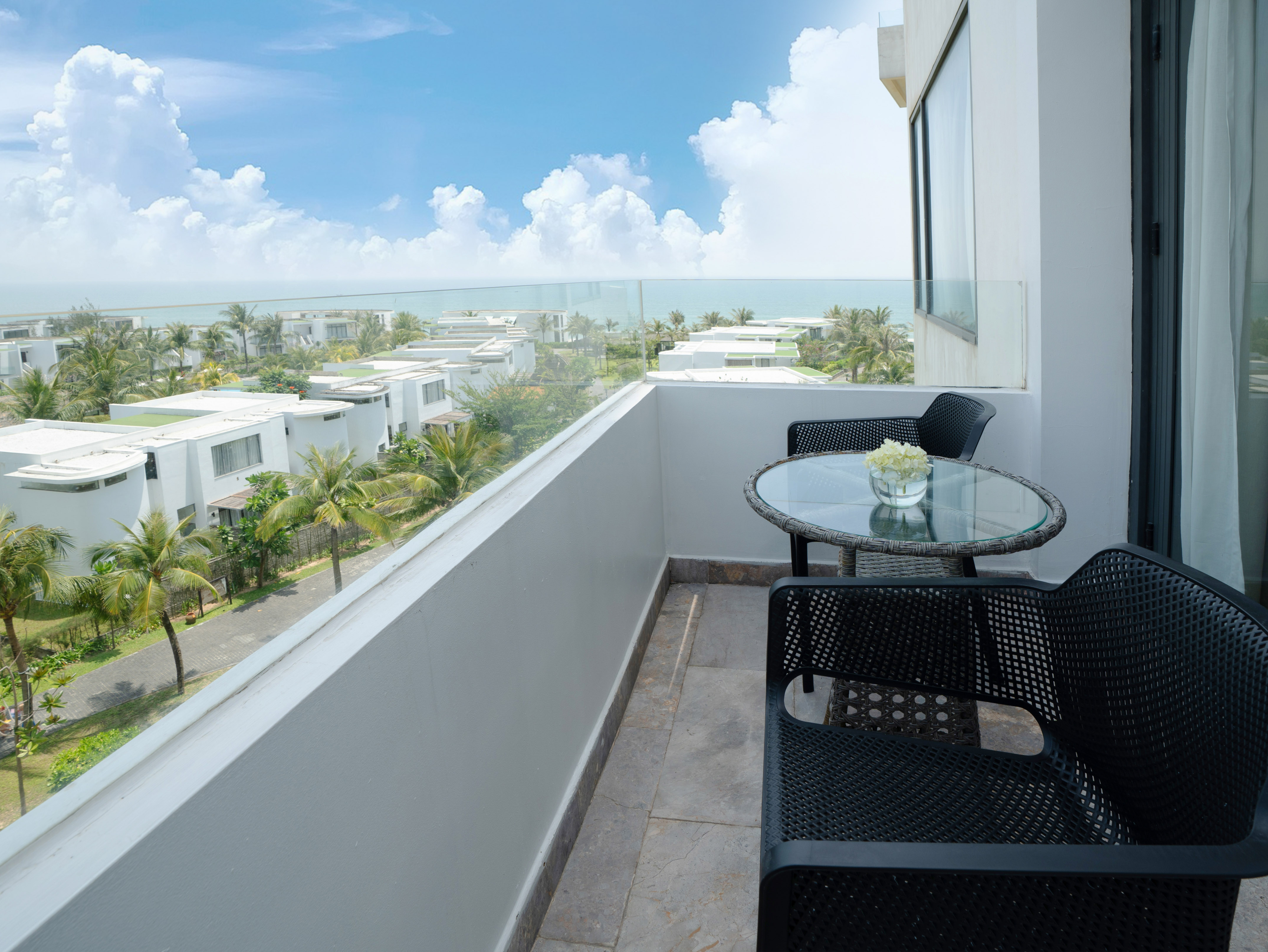 a balcony with chairs and table