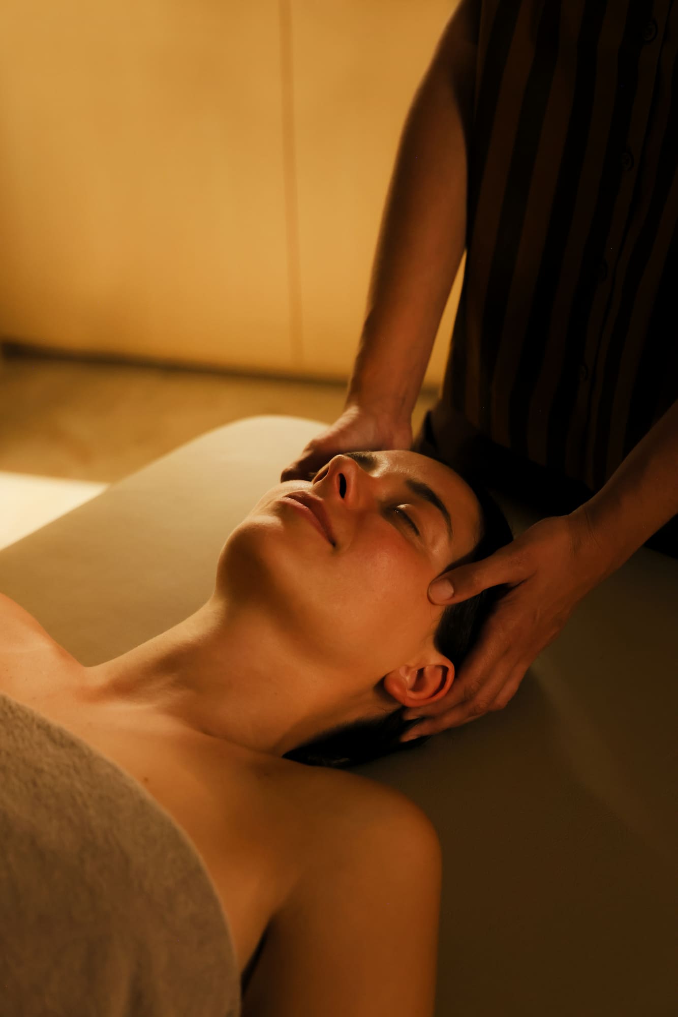 a person massaging a woman's face