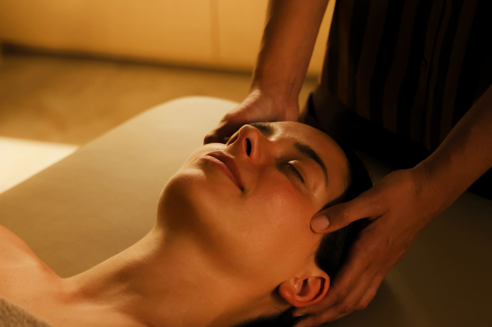 a person massaging a woman's face