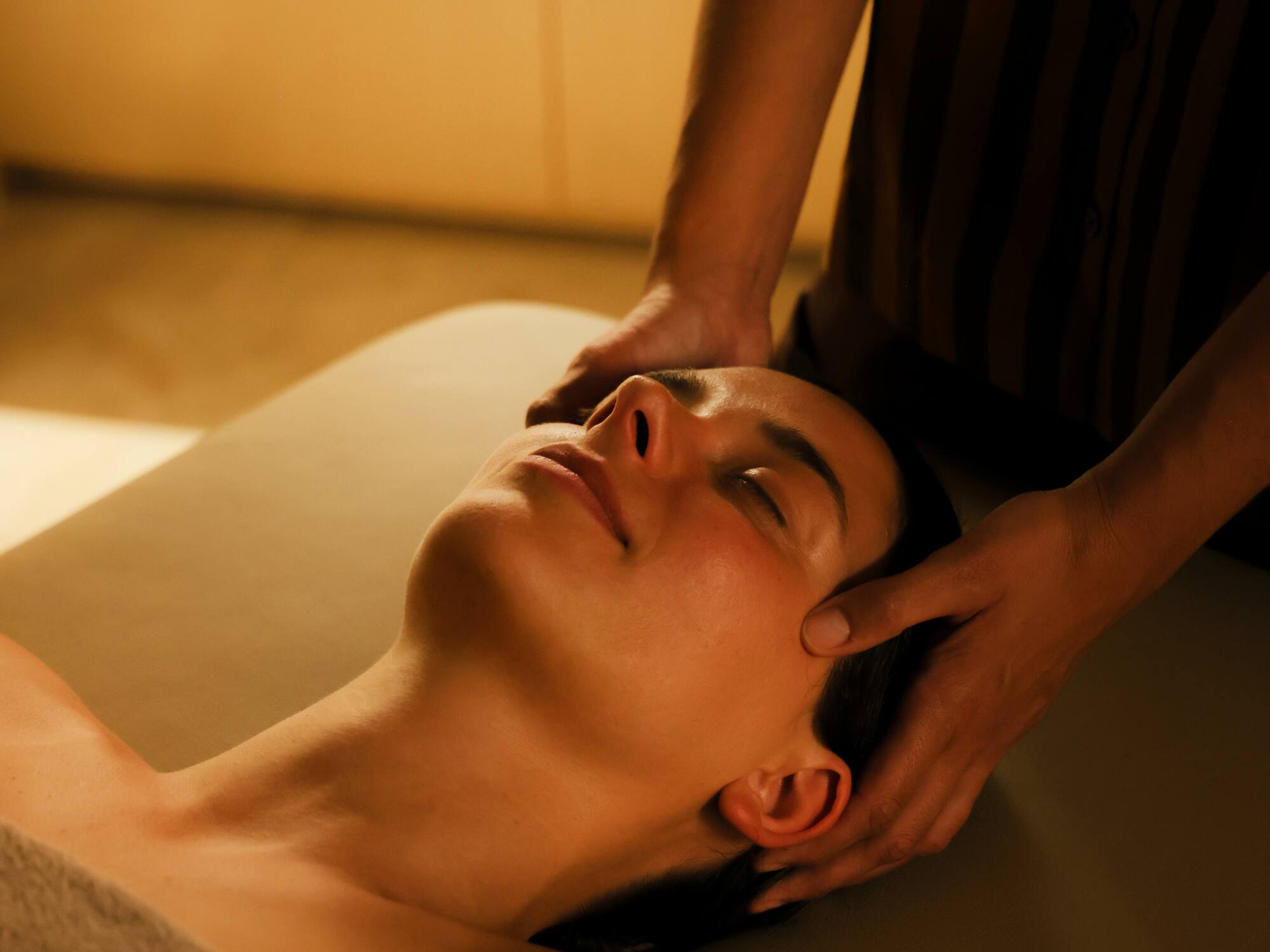 a person massaging a woman's face