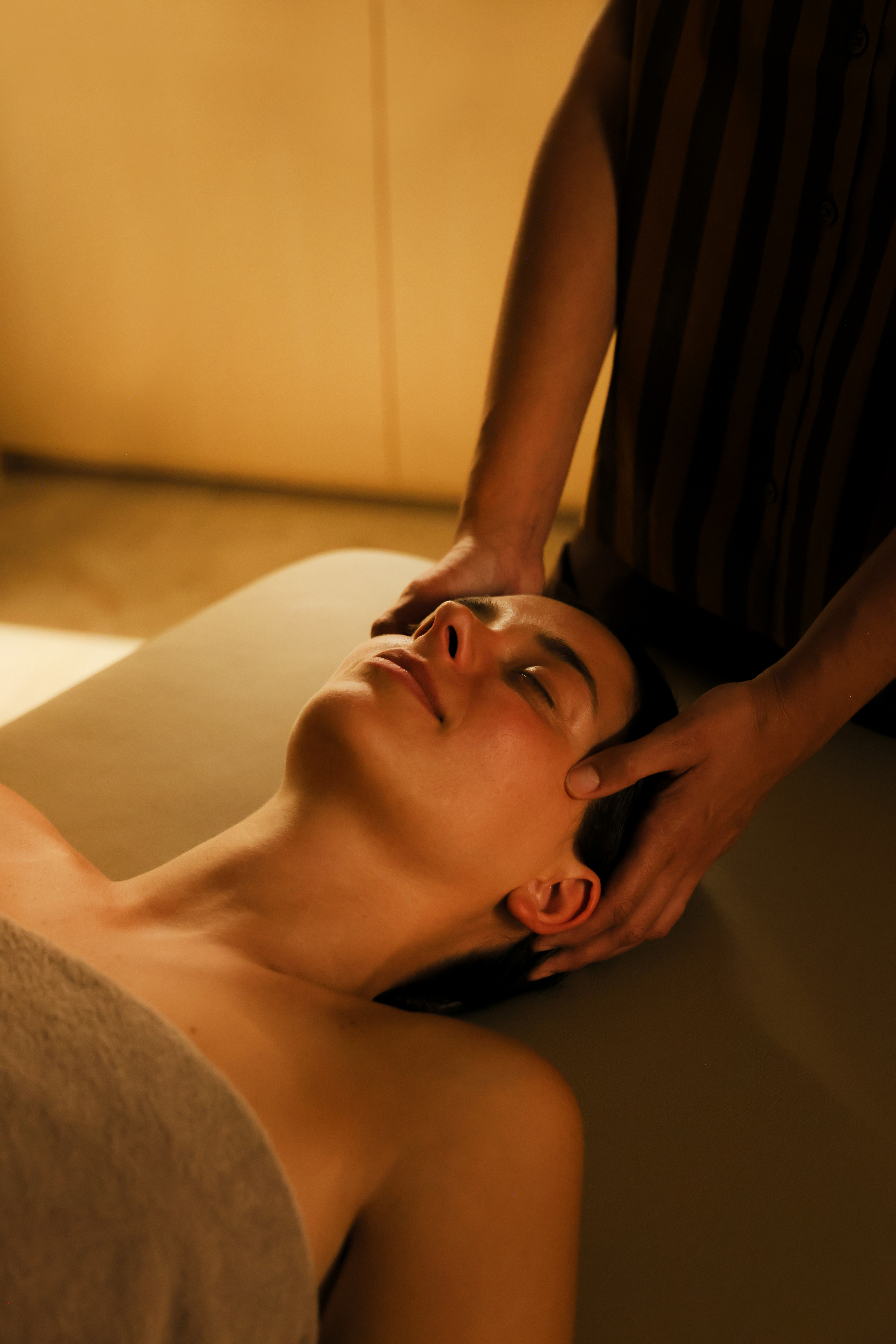 a person massaging a woman's face