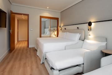 a room with two beds and a mirror