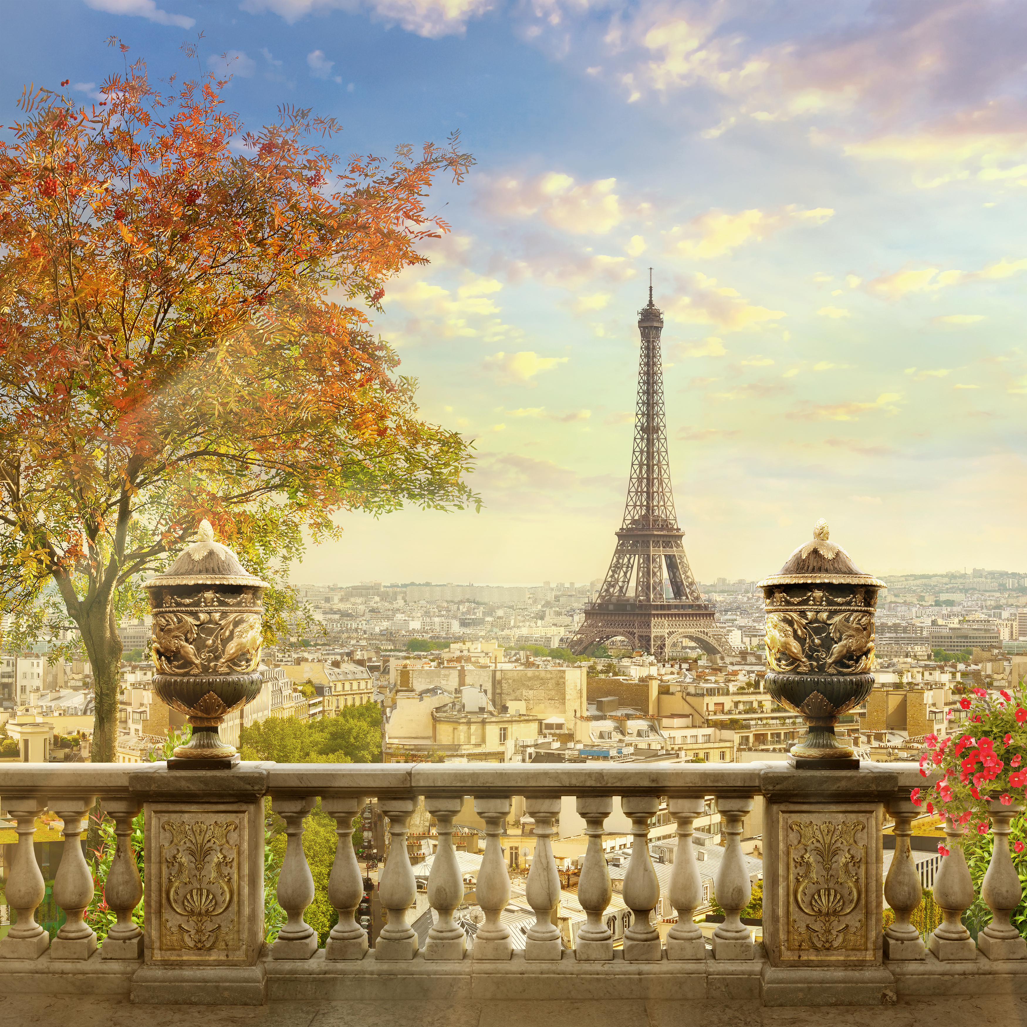 Eiffel Tower over autumn Paris from a balustrade with decorative urns.