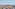 Lisbon cityscape from rooftop terrace with São Jorge Castle and Tagus River.