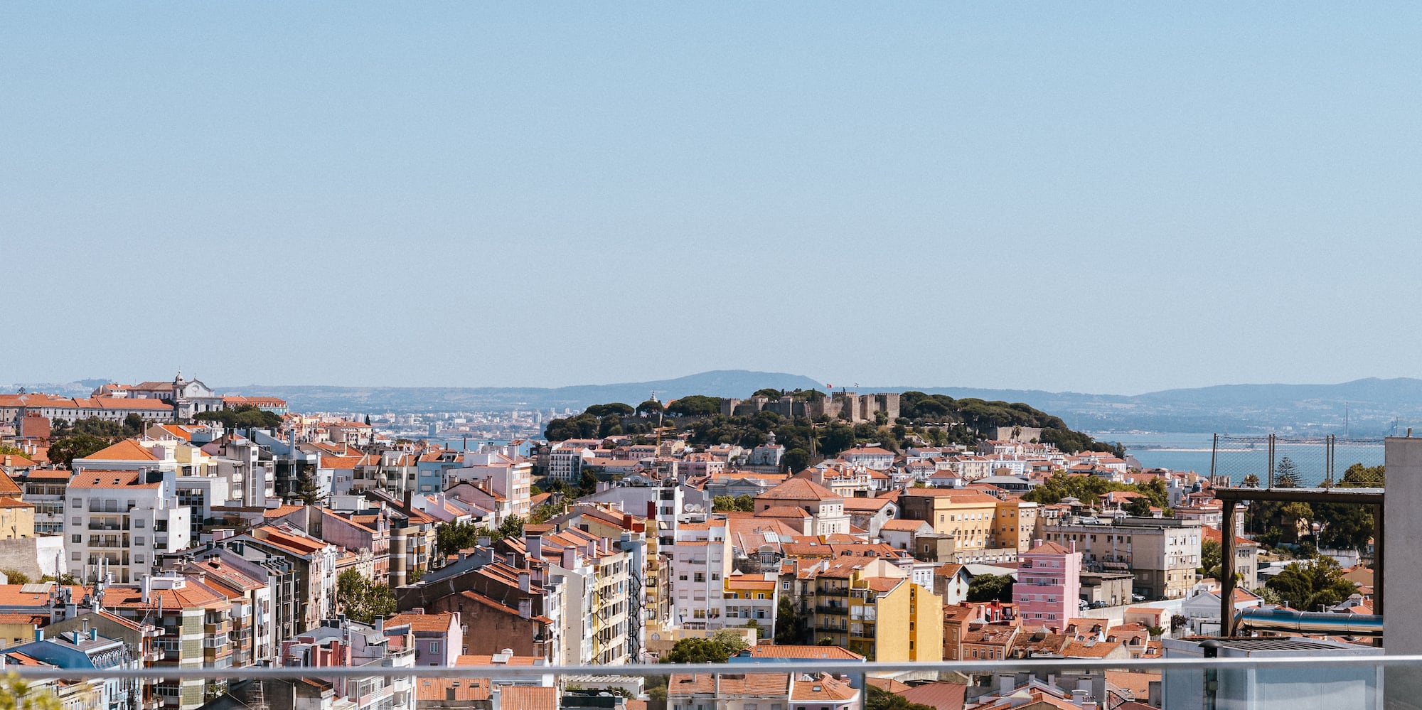 a city with many buildings and a blue sky