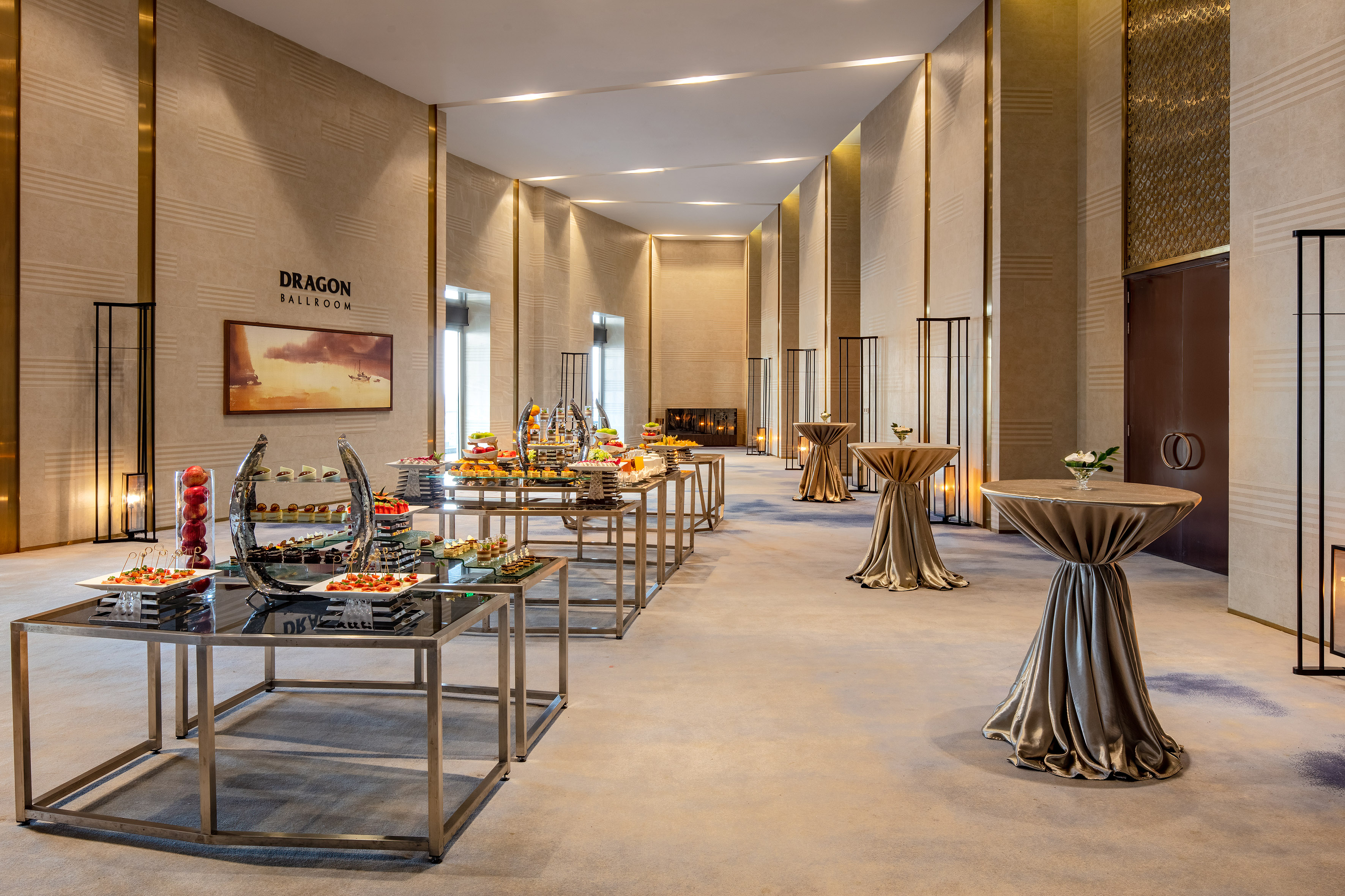 Elegant Dragon Ballroom event space with buffet food displays and draped cocktail tables.