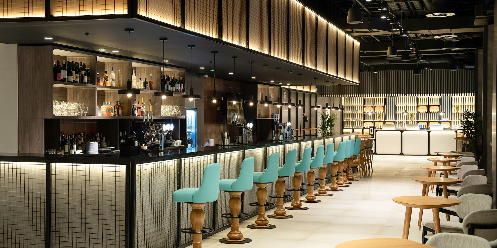 a bar with blue chairs and tables