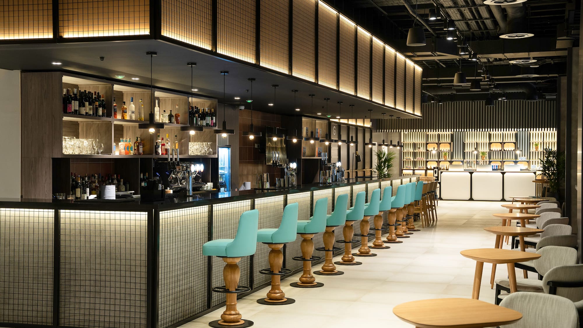 a bar with blue chairs and tables