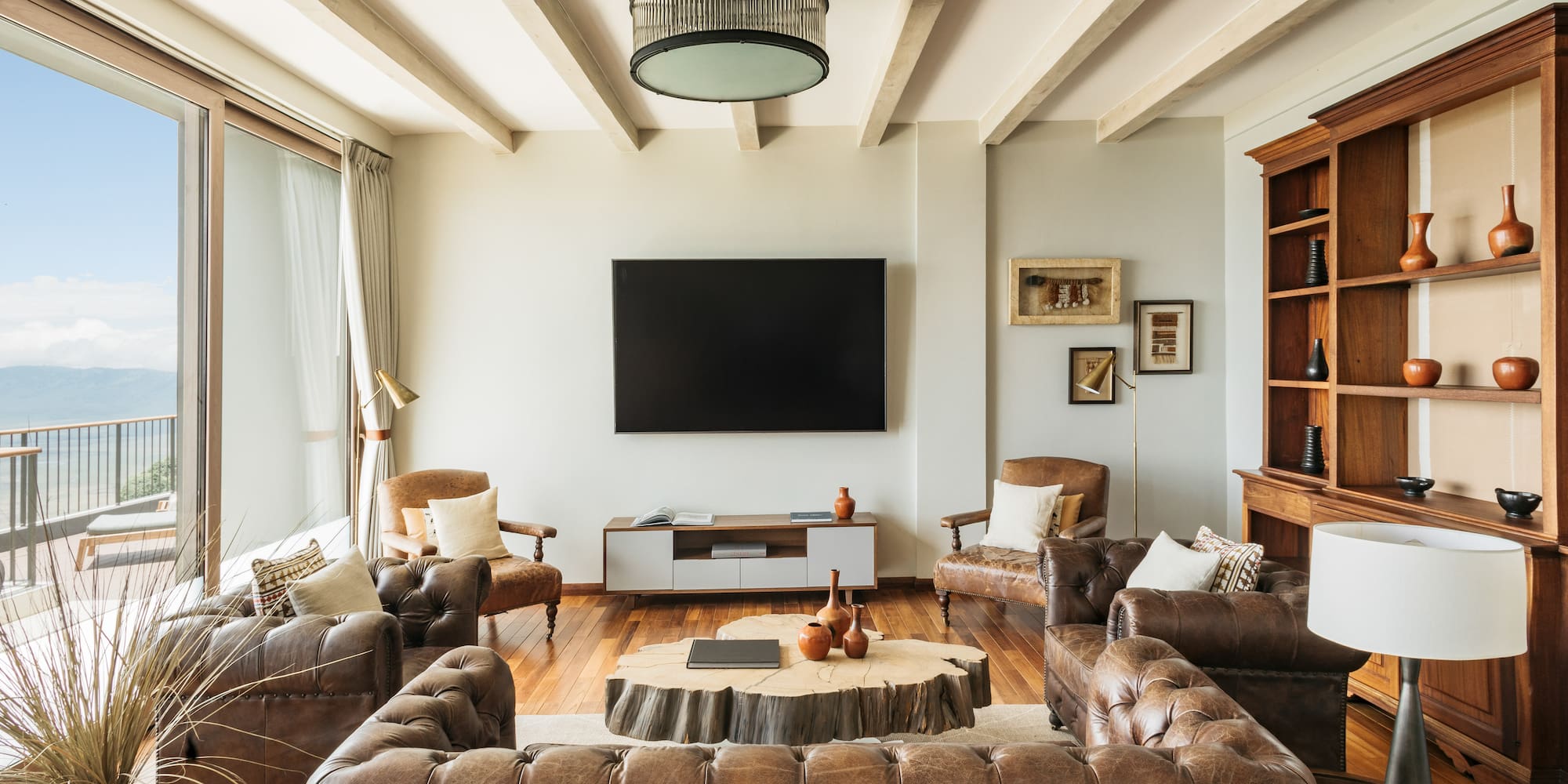 a living room with leather couches and a tv