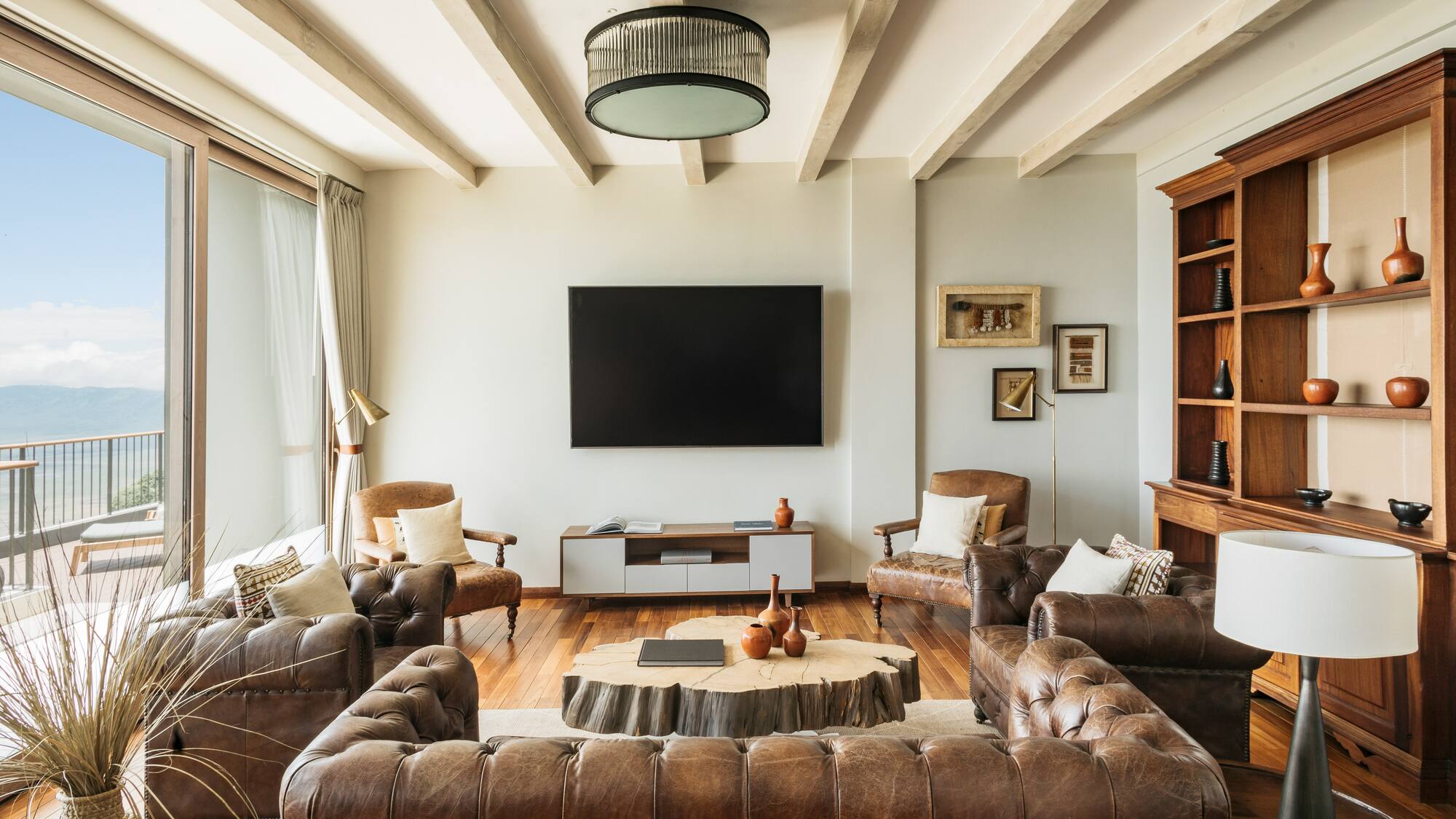 a living room with leather couches and a tv