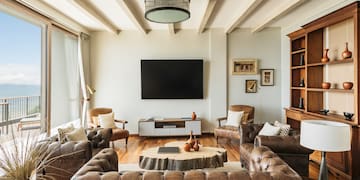 a living room with leather couches and a tv