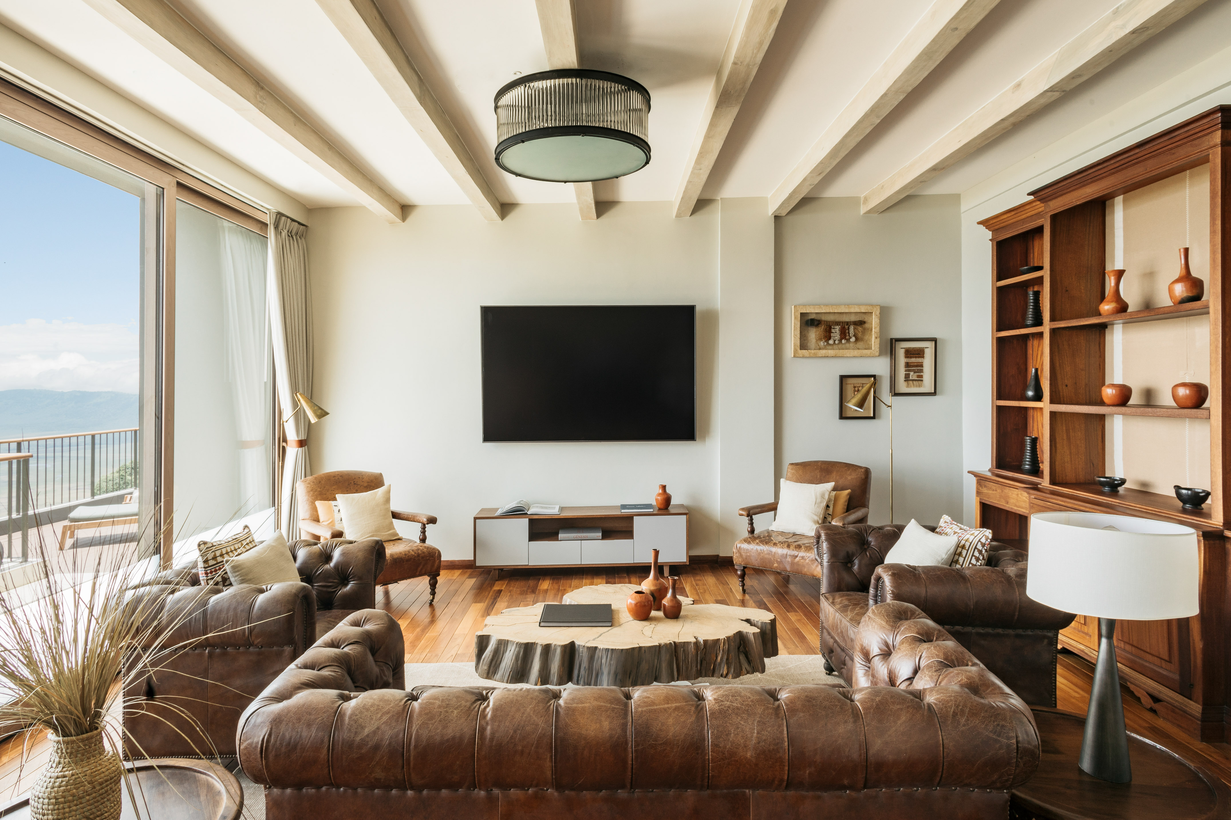 a living room with leather couches and a tv