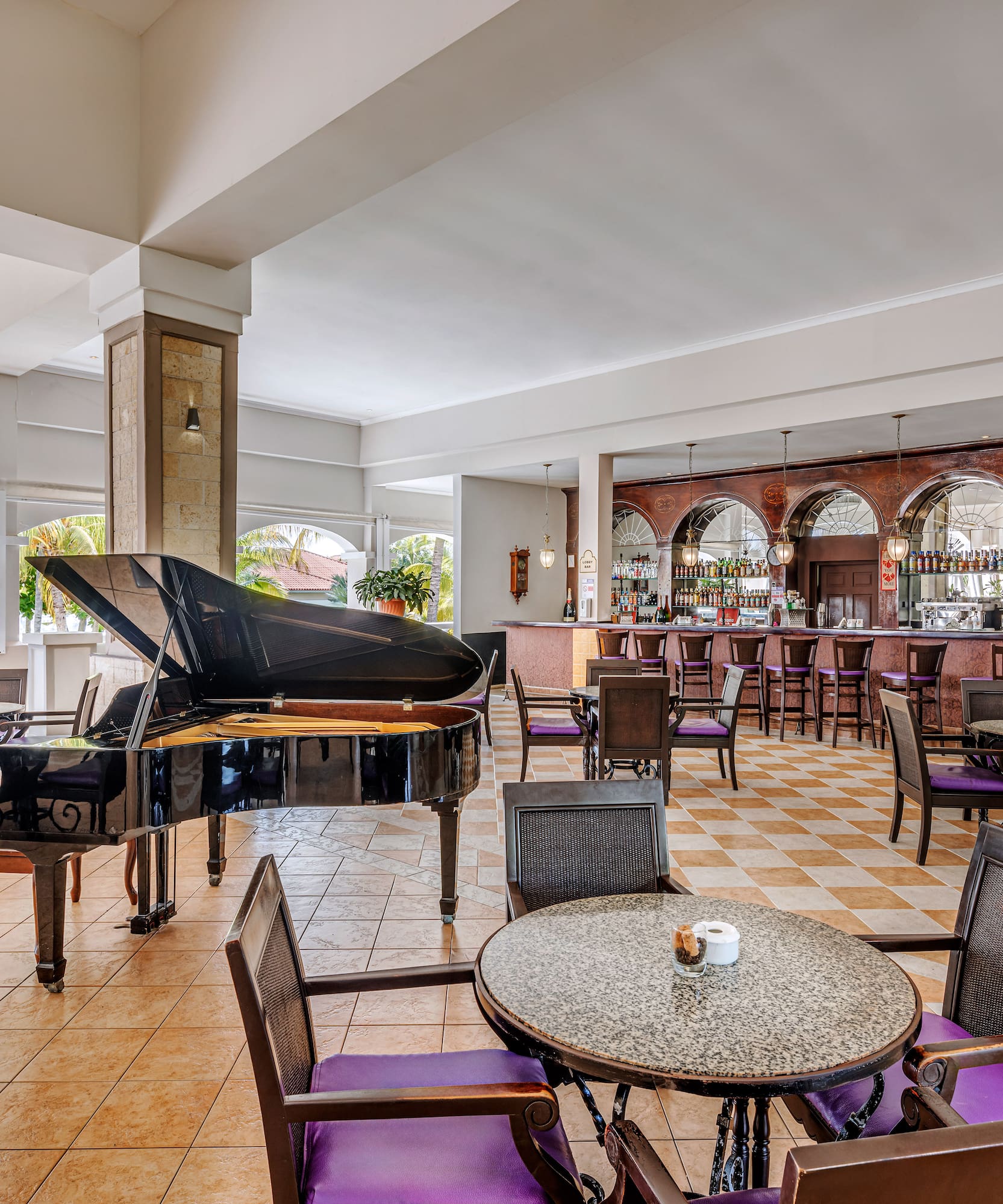 a room with a piano and chairs
