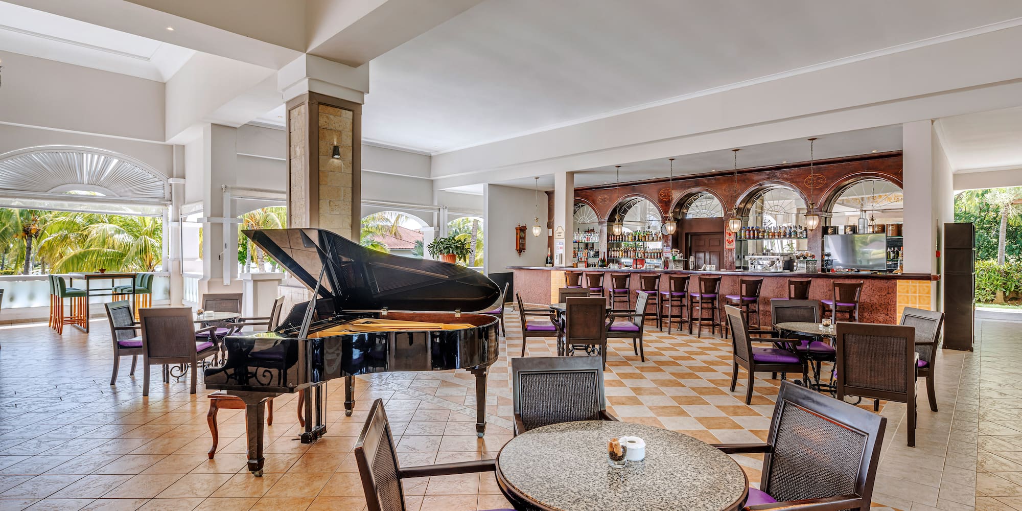 a room with a piano and chairs