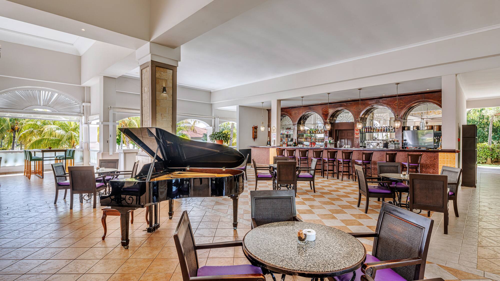 a room with a piano and chairs