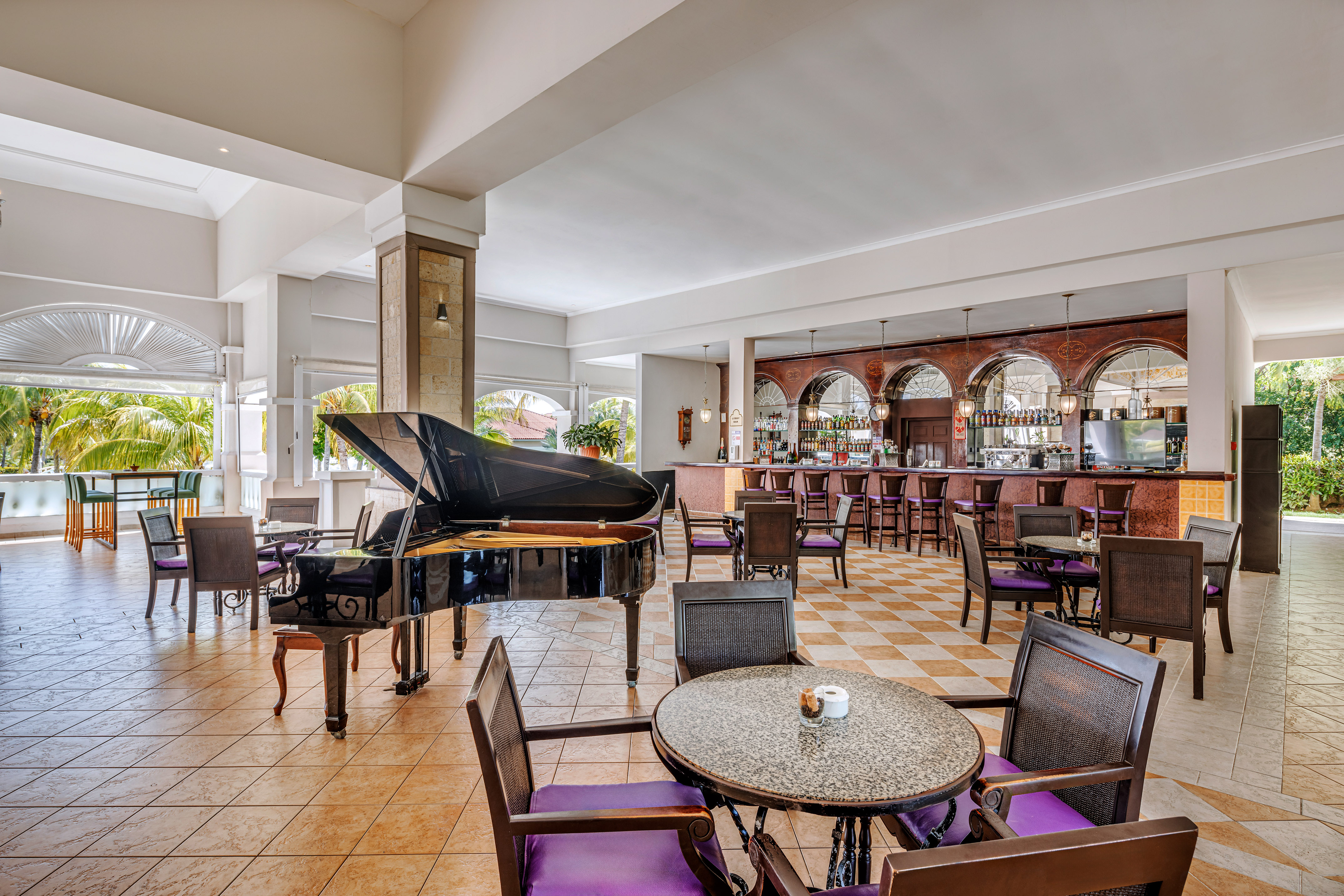 a room with a piano and chairs