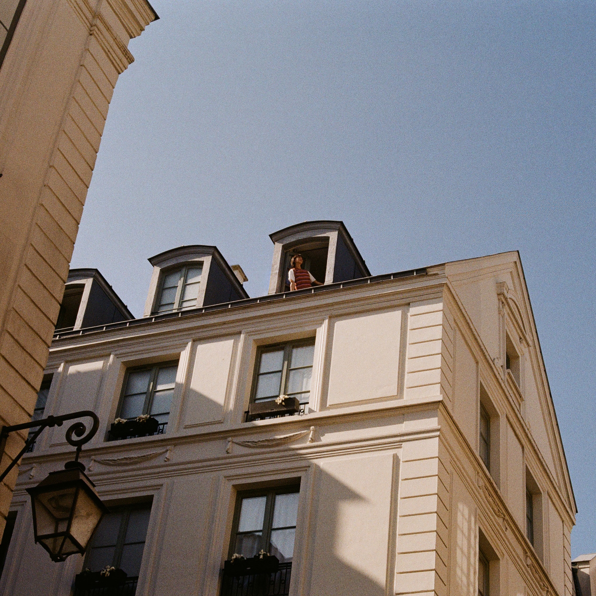 a person standing on a balcony of a building
